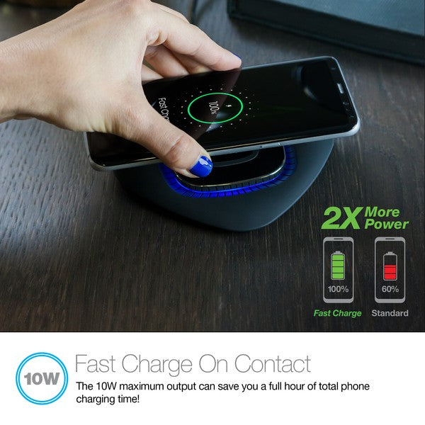 A black Naztech wireless charging pad with a glowing blue ring, actively charging a smartphone via Qi technology. Includes a USB wall adapter.