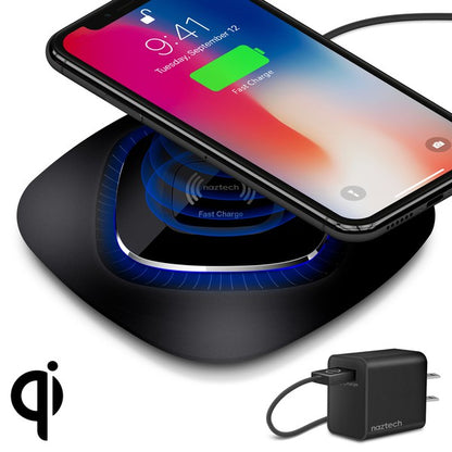 A black Naztech wireless charging pad with a glowing blue ring, actively charging a smartphone via Qi technology. Includes a USB wall adapter.