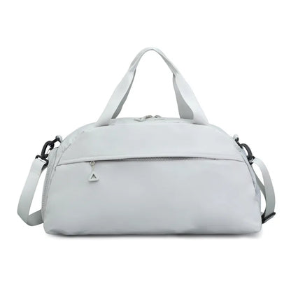 Light gray duffel bag with a clean, minimalist design, featuring short handles, a long adjustable shoulder strap, and a front zippered pocket with a triangular pull. Sleek and functional—ideal for gym, travel, or everyday use.