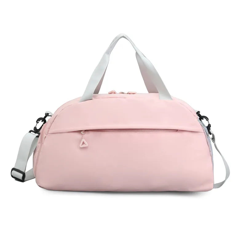 Light pink duffel bag with white handles and a detachable shoulder strap, featuring a front zippered pocket with a triangular pull. Sleek and functional—perfect for gym, travel, or everyday use.