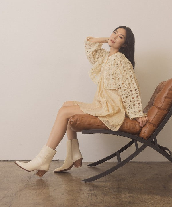 Leather ankle boots with square toe, stacked wooden block heel, side zipper closure, and slip-on style
