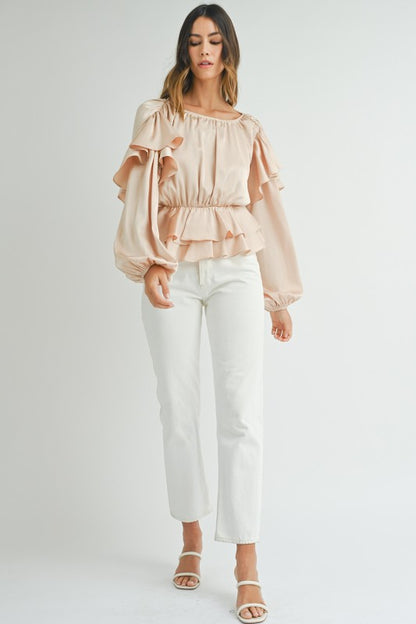 Ruffled peplum hem creates a flattering silhouette. 