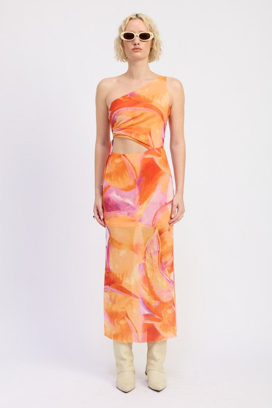 A model wearing a vibrant one-shoulder maxi dress with an abstract orange, pink, and yellow print. The dress features a cutout at the waist and a slim, straight silhouette, paired with cream knee-high boots and sunglasses