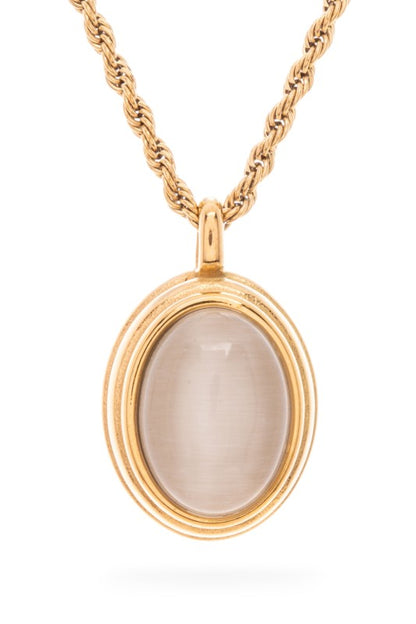 A gold necklace with a pendant. The pendant is circular with a light pink stone in the center, surrounded by gold.