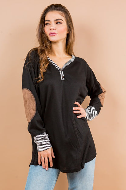 Oversized tunic with contrasting sleeves and suede elbow patches for a cozy, stylish twist.