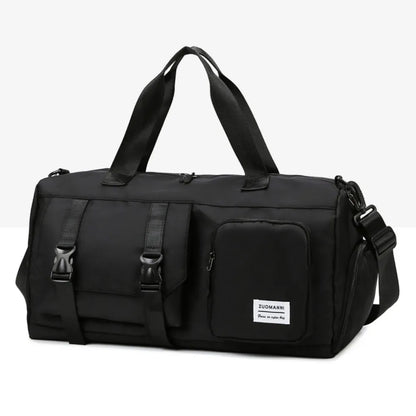 Black duffel bag with top handles and a detachable shoulder strap. Features include a front zip pocket and a buckle-strap compartment. Durable and versatile—ideal for travel, gym, or daily use.