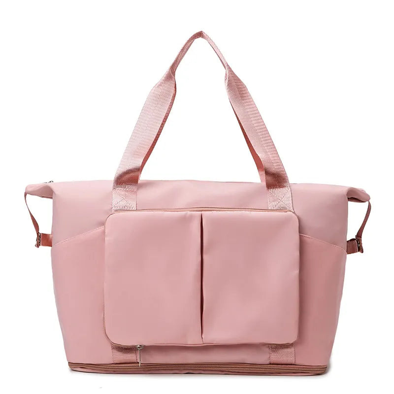Sleek pink travel or gym bag with sturdy textured shoulder straps, dual vertical front pockets with flap, and a reinforced base. Designed for durability and spacious storage—ideal for active or travel lifestyles.