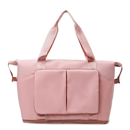 Sleek pink travel or gym bag with sturdy textured shoulder straps, dual vertical front pockets with flap, and a reinforced base. Designed for durability and spacious storage—ideal for active or travel lifestyles.