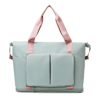 Light green tote bag with pink handles and accents, featuring dual front pockets, side compartments, and a bottom zip section. Stylish and spacious—perfect for gym, travel, or everyday use.Light blue tote bag with pink handles and accents, featuring dual front pockets, side compartments, and a bottom zip section. Stylish and spacious—perfect for gym, travel, or everyday use.