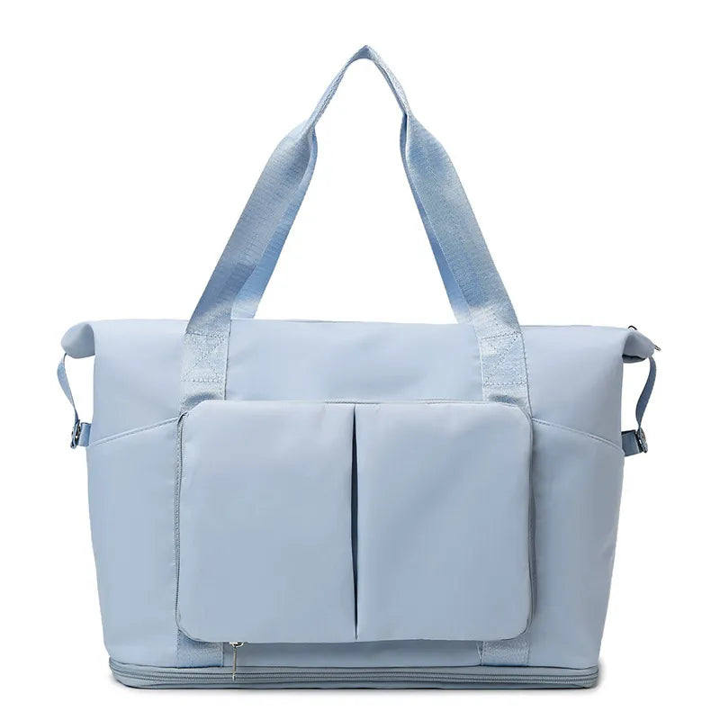 Light green tote bag with pink handles and accents, featuring dual front pockets, side compartments, and a bottom zip section. Stylish and spacious—perfect for gym, travel, or everyday use.Light blue tote bag with pink handles and accents, featuring dual front pockets, side compartments, and a bottom zip section. Stylish and spacious—perfect for gym, travel, or everyday use.
