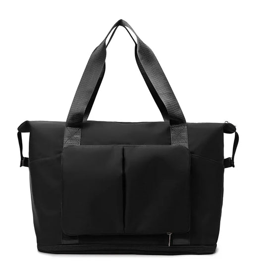 Sleek black travel or gym bag with sturdy textured shoulder straps, dual vertical front pockets with flap, and a reinforced base. Designed for durability and spacious storage—ideal for active or travel lifestyles.