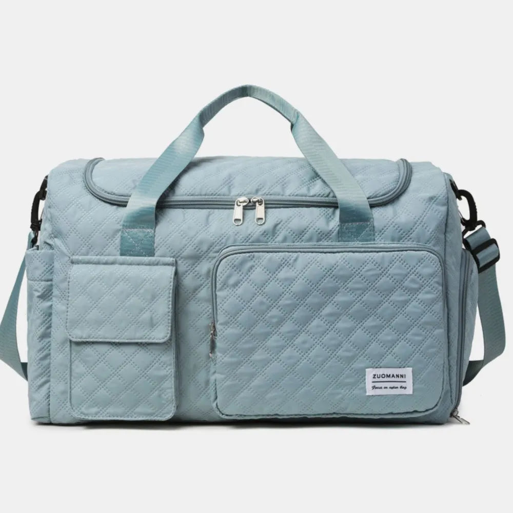 Green quilted duffel bag with green straps, featuring a zip pocket and flap pocket on the front. Stylish and functional for travel or gym use.