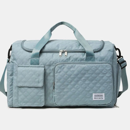 Green quilted duffel bag with green straps, featuring a zip pocket and flap pocket on the front. Stylish and functional for travel or gym use.