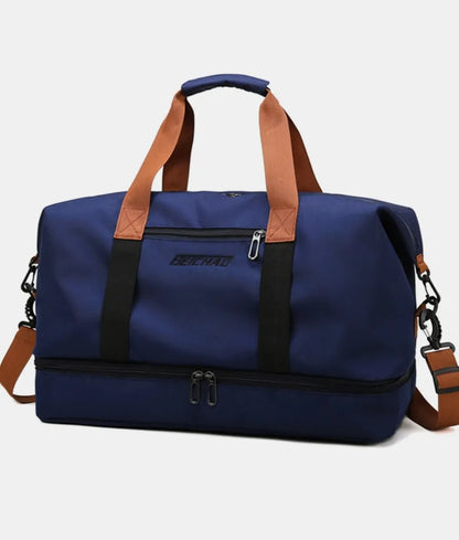 Navy blue duffel bag with brown handles and black straps, featuring top and bottom zippered compartments and a front label. Durable and stylish—ideal for gym, travel, or everyday use.
