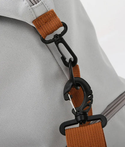Light gray duffel bag with brown and black straps, featuring a zippered top compartment and an additional bottom section. Sleek and functional—ideal for gym, travel, or everyday use.