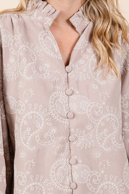 Long sleeves and a split V-neck balance classic shape with delicate eyelet detail.