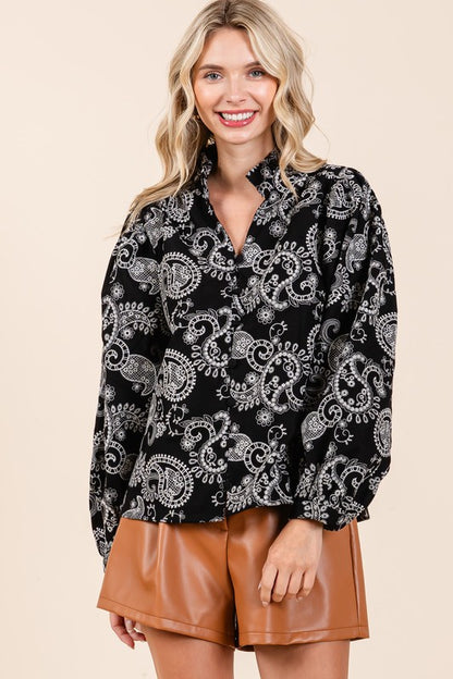 Elegant embroidery meets feminine structure in this eyelet lace button-up top.