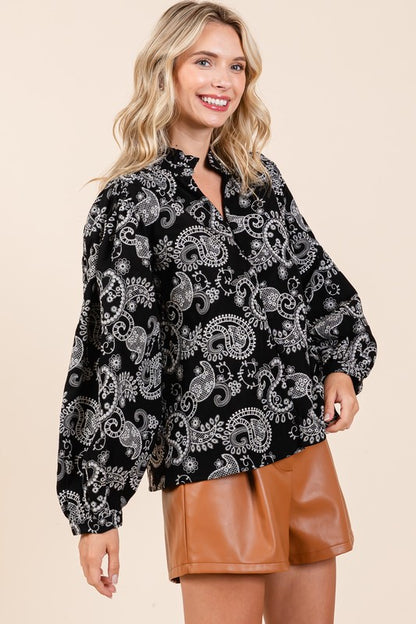 Ruffle trim at the neckline gives this blouse a delicate, vintage-inspired touch.
