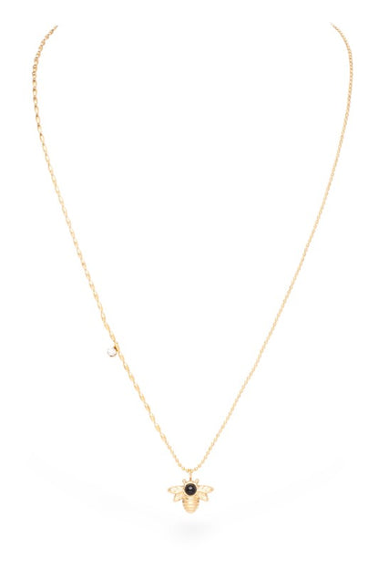 Gold bee pendant necklace featuring a black gemstone at the center, with detailed wings and a textured chain.