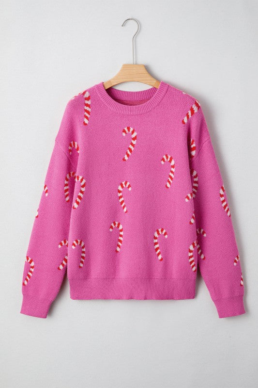 Pink knit sweater with candy cane pattern on white background