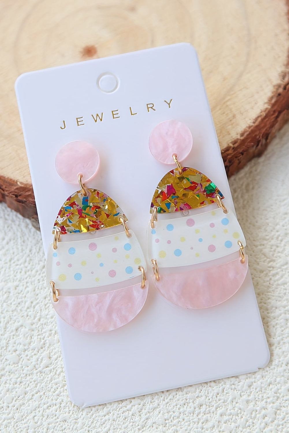 Hop into spring with a little sparkle. These adorable Easter egg-shaped drop earrings are the perfect way to celebrate the season in style. Featuring a soft pink hue and whimsical printed patterns, they’re sweet, festive, and totally charming.