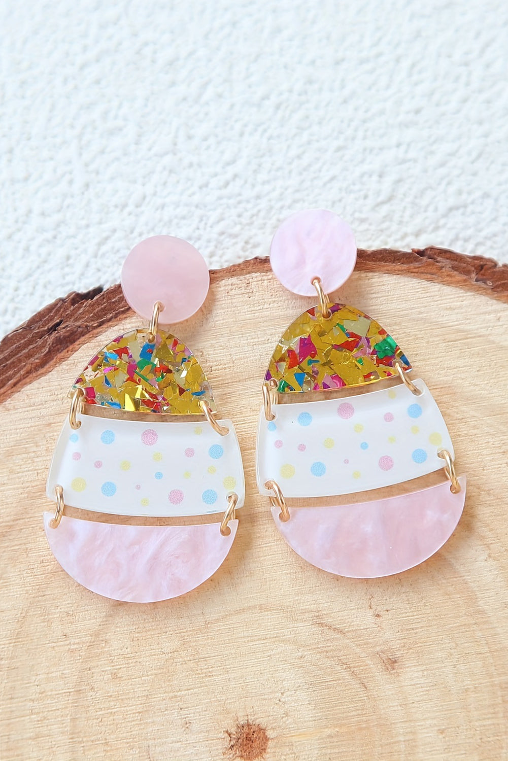 Hop into spring with a little sparkle. These adorable Easter egg-shaped drop earrings are the perfect way to celebrate the season in style. Featuring a soft pink hue and whimsical printed patterns, they’re sweet, festive, and totally charming.
