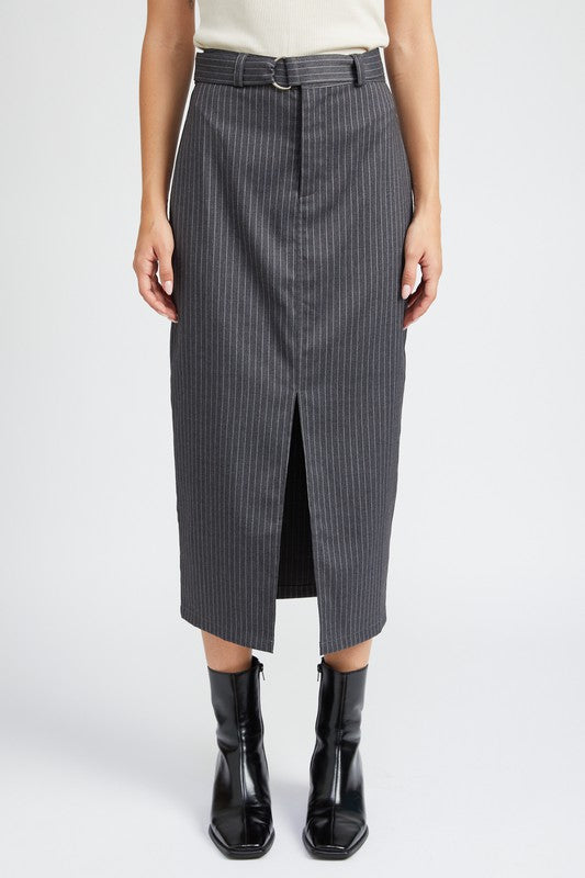 Person wearing a gray pinstripe skirt with a white top and black boots on a light gray background