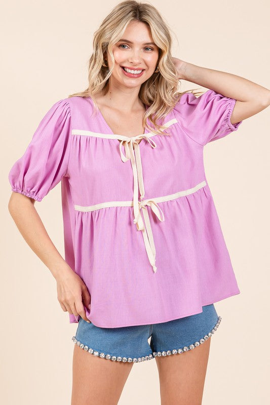 Piped trim adds definition to a soft, flowing babydoll silhouette.
