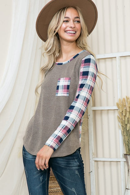 Lightweight pullover blending solid knit and plaid print for a fresh take on cozy.