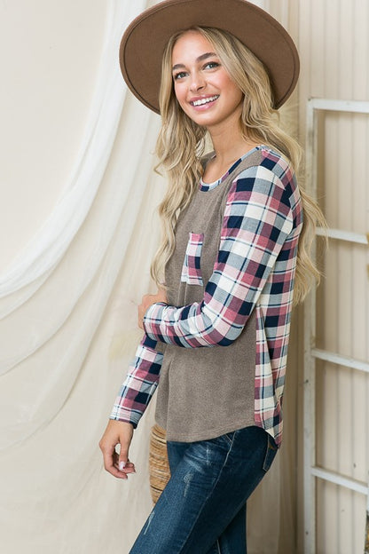 Plaid contrast accentuates the shoulders and cuffs for a stylish statement.