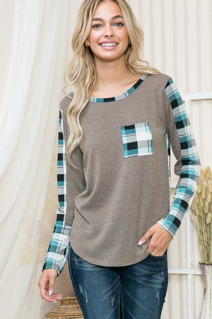 A modern sweater that merges relaxed shape with tailored plaid accents.