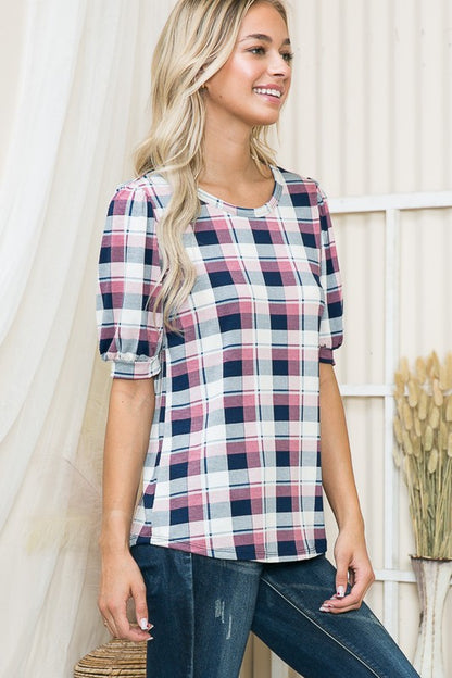 Eye-catching plaid print elevated by voluminous shoulders.