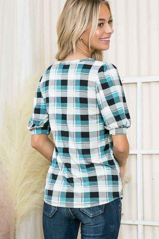 Mixes classic plaid with contemporary puff sleeve design for standout appeal.
