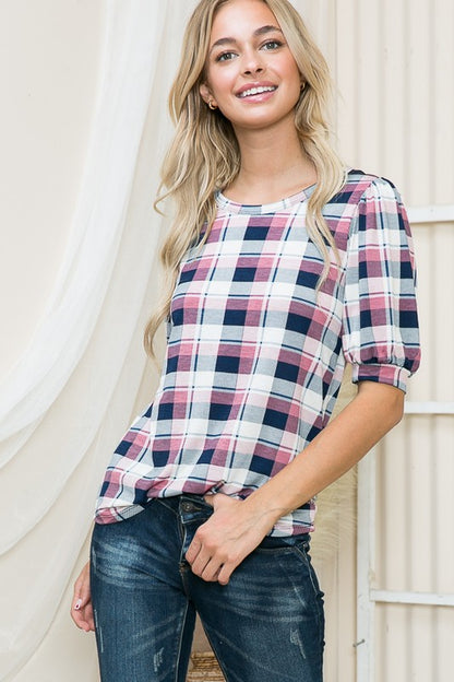 Plaid pattern meets puff sleeves for a bold, feminine touch.