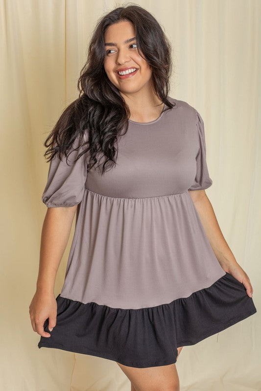 Woman wearing a two tiered mini dress with sleeves