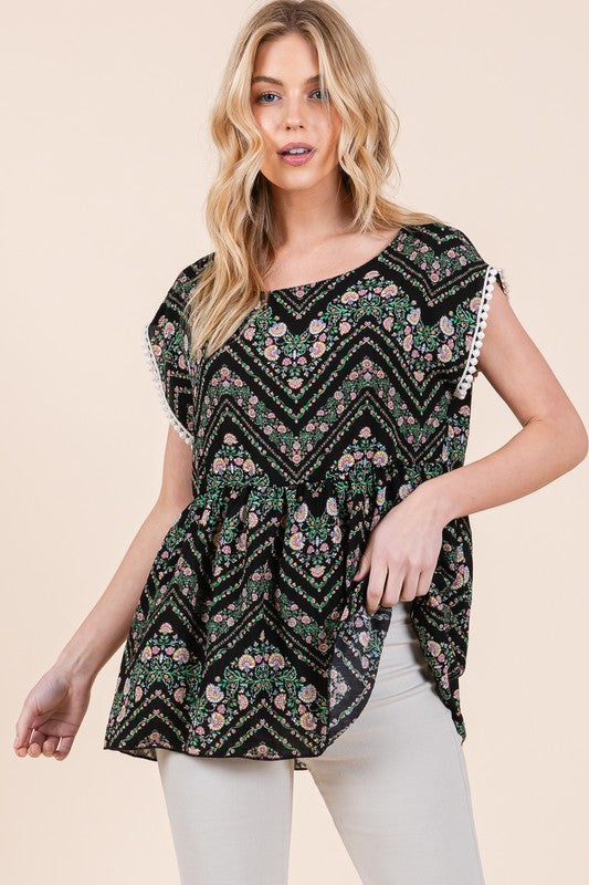 Lace and texture mingle in this tunic, complete with whimsical pom-pom edging.