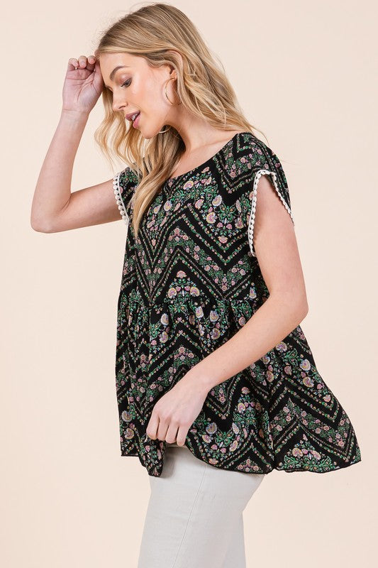 Lightweight tunic with lace detail and pom-pom trim adds fun flair to your outfit.