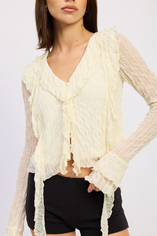 Ruffles along the shoulders add romantic texture and movement. 