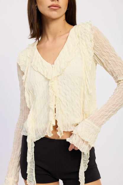 Ruffles along the shoulders add romantic texture and movement. 