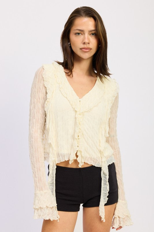 Long sleeves provide full coverage with a feminine ruffle detail at the cuff. 