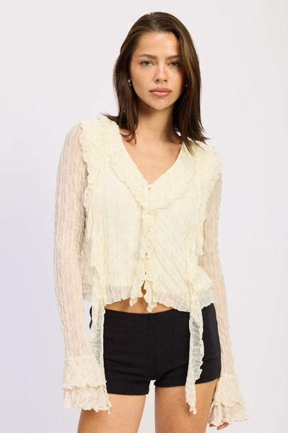 Long sleeves provide full coverage with a feminine ruffle detail at the cuff. 