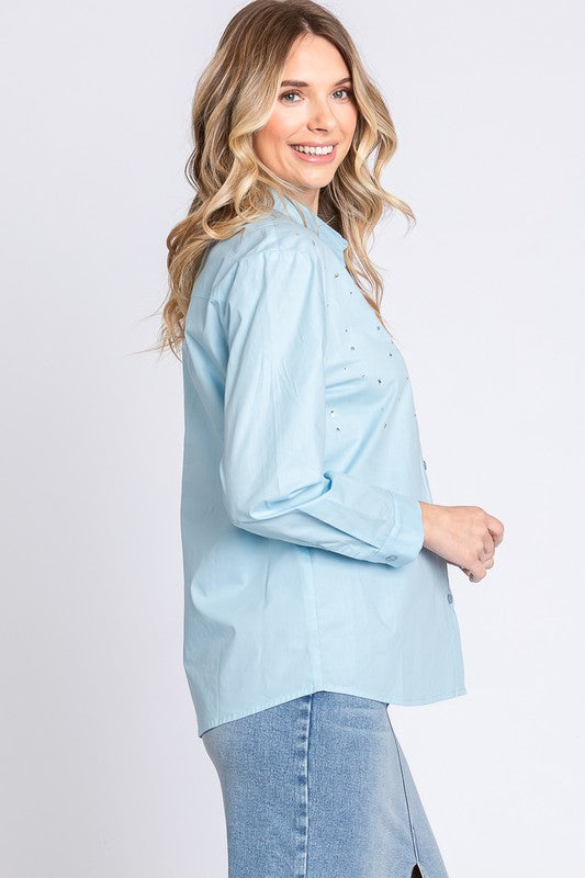 Elegant and eye-catching, this blouse combines structure and sparkle for day or evening.