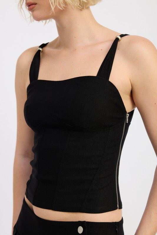 Ring-strap detail adds a bold, modern hardware accent. 