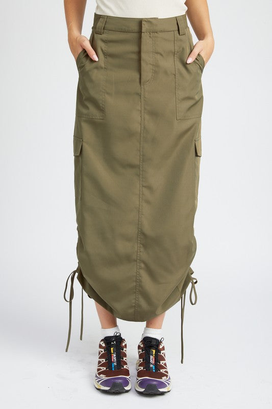 Person wearing a green cargo skirt with pockets on a white background