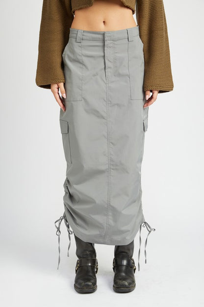 Person wearing gray cargo skirt with drawstrings on the sides