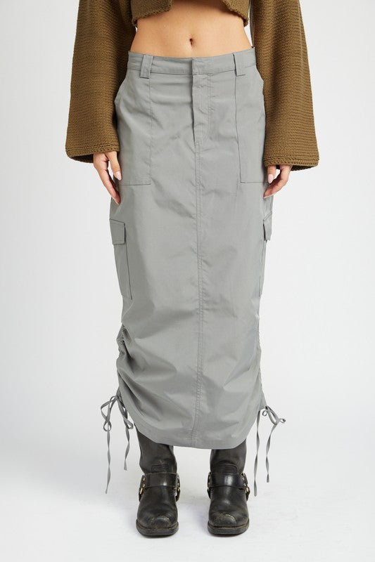 Person wearing gray cargo skirt with drawstrings on the sides