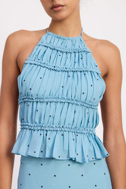 Ruffle trim along the neck and bodice brings feminine movement and detail.