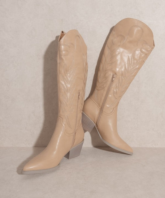 Knee-high western boots with embroidered stitching, pointed toe, stacked block heel, and side zipper closure.