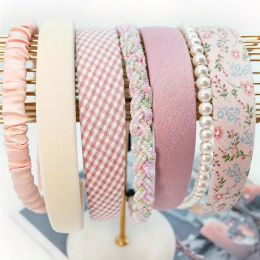 Set of seven pink headbands in assorted styles and textures — soft, stretchy, and perfect for everyday wear or accessorizing outfits
