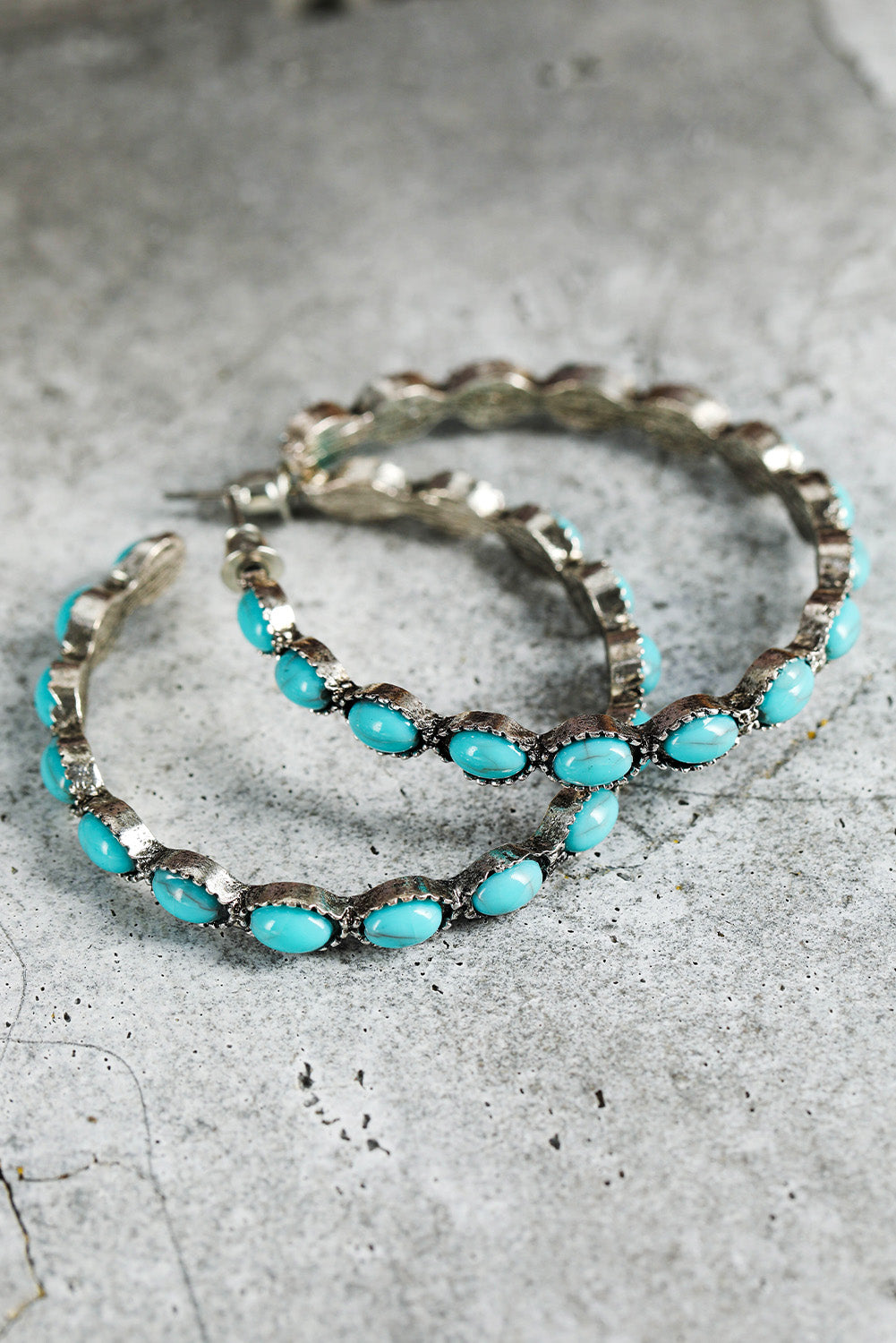 Vintage vibes, modern sparkle. These retro-inspired C-shape earrings are a dreamy blend of bold design and delicate detail. Featuring a smooth gold-tone curve inlaid with sky blue gems, they catch the light—and compliments—with every turn of your head.